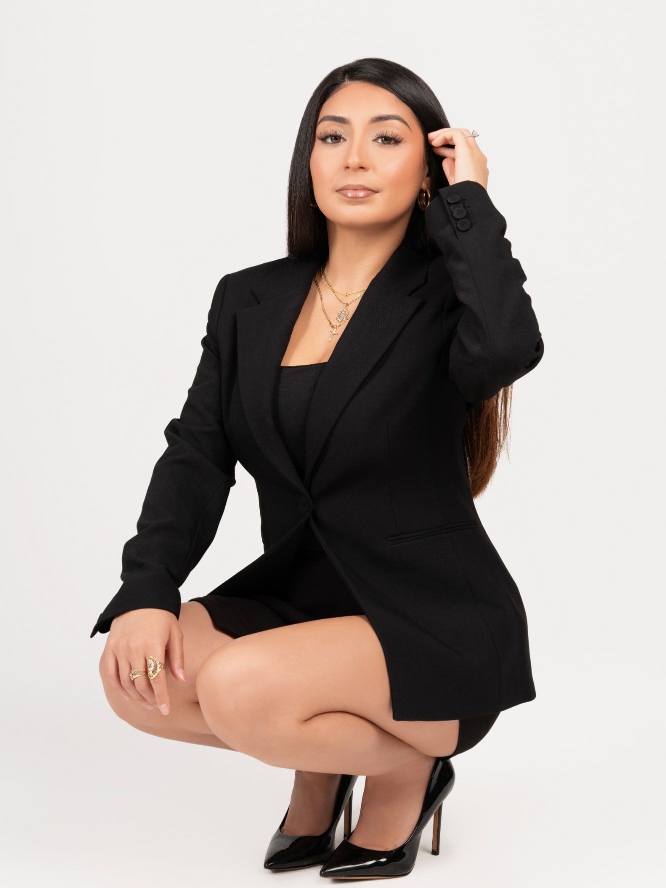 Mercedez, licensed esthetician and lash artist, in a black suit